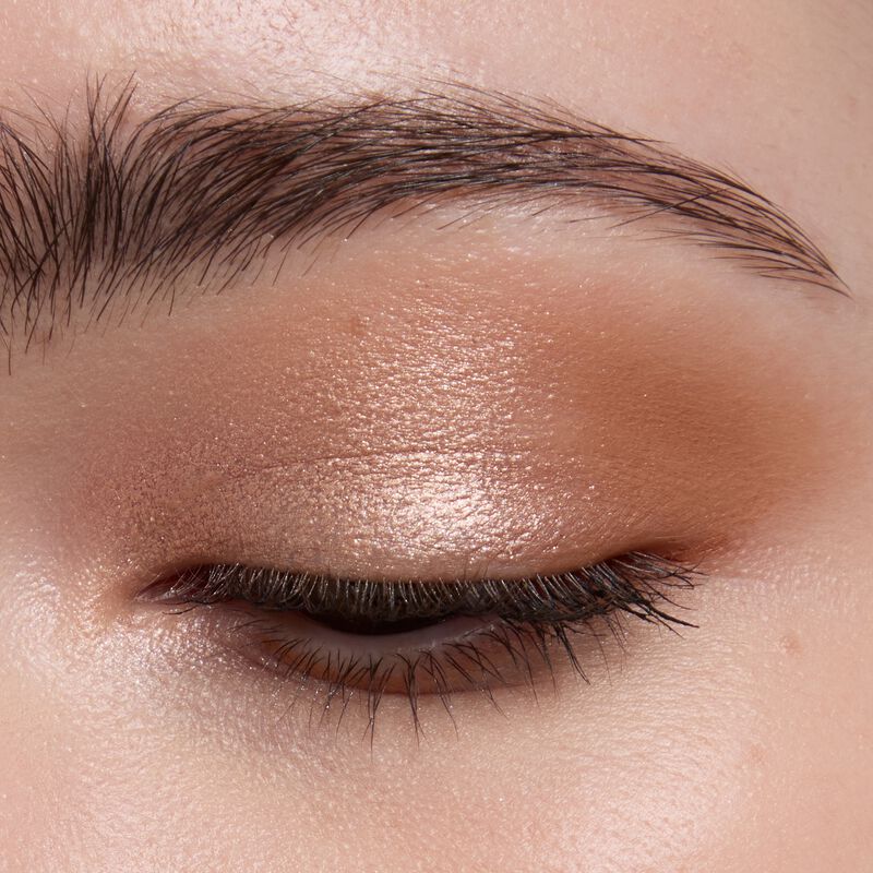 Lightskinned model wearing Mary kay Eye Shadow Sticks in shades Golden Sunrise and Orbit Clay